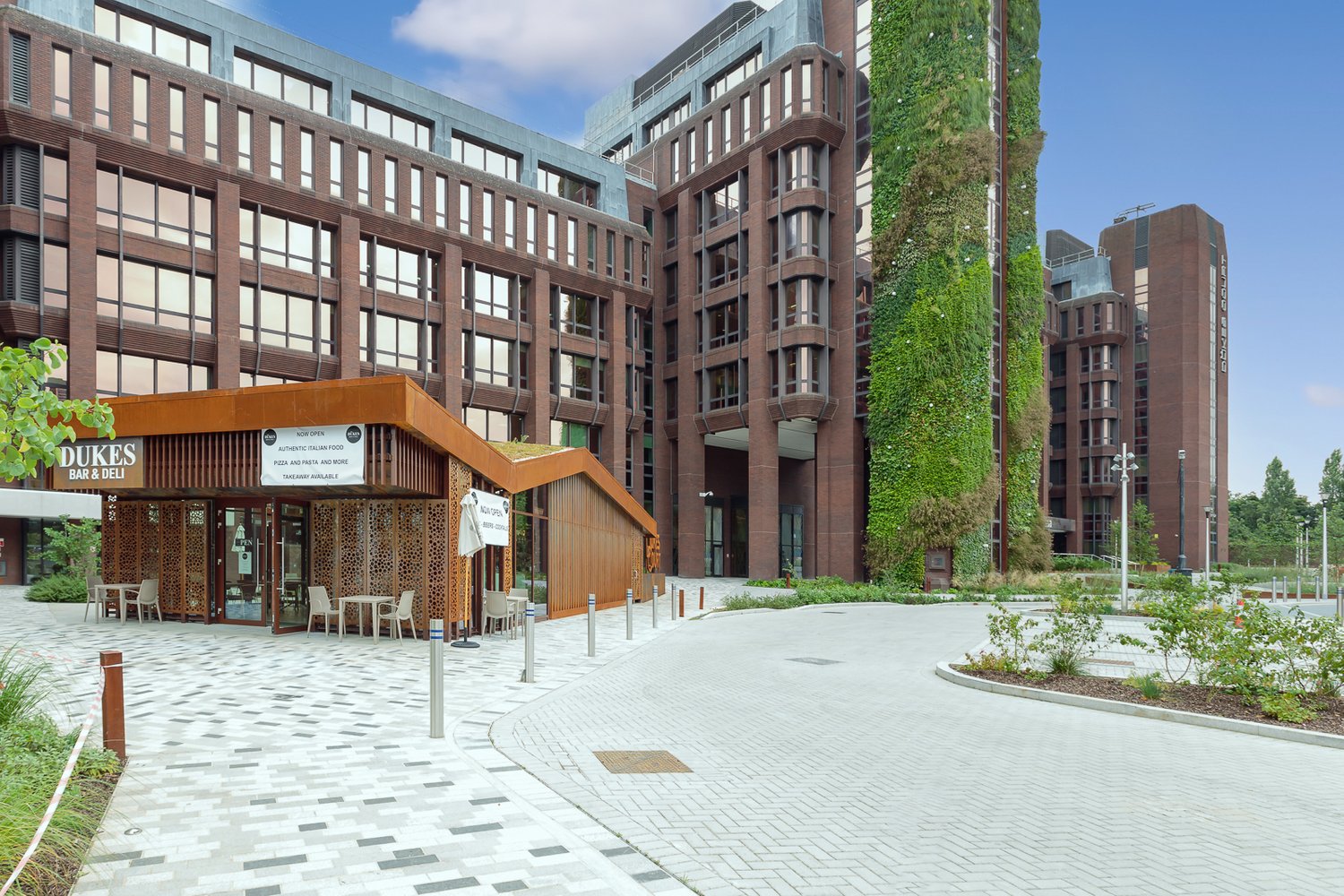 Duke's retail kiosk at Dukes Court in Woking with tall living green wall in the background