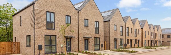 Row of modular houses in light brickwork and gable roofs designed by Peter Dann Consulting Engineers for Legal and General modular homes