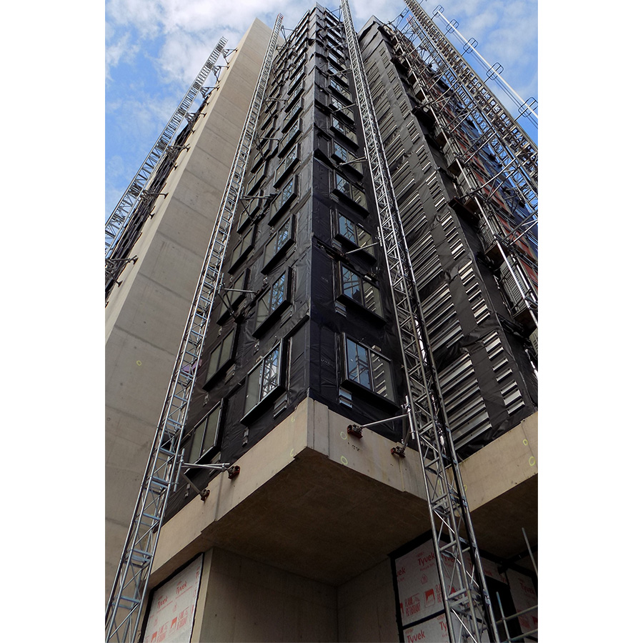 Exterior facade of modular tower looking upwards towards blue sky