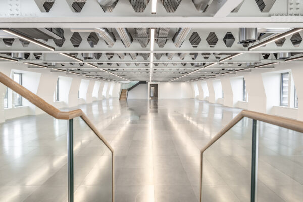 White office interior after refurbishment with shiny floor and downstand beams