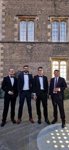 Four male engineers in black tie standing outside Jesus College for the CFCI Next Gen events 2024