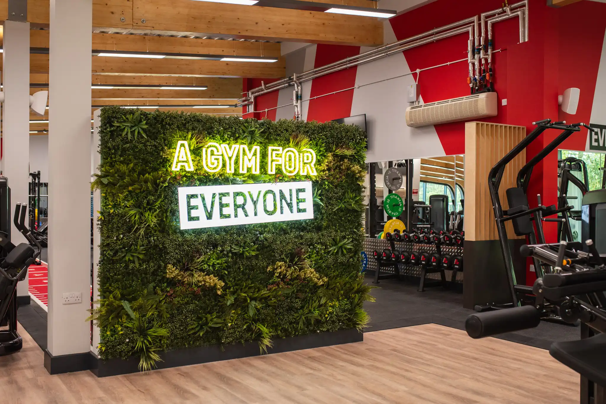 Hartham Leisure Centre gym refurbishment interior showing a small living wall with neon sign that reads 'a gym for everyone'