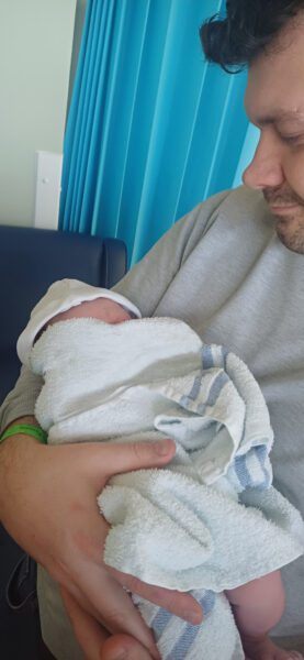 Dad with new born wrapped in a towel