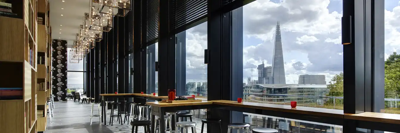 Modular hotel citizenM Bankside looking out of glass windows to the shard