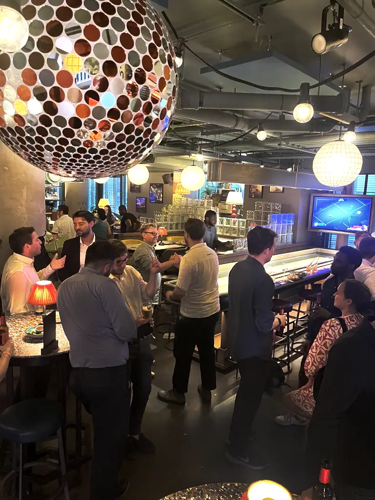 Electric shuffle board night with the London Development Network social team indoors shuffle board