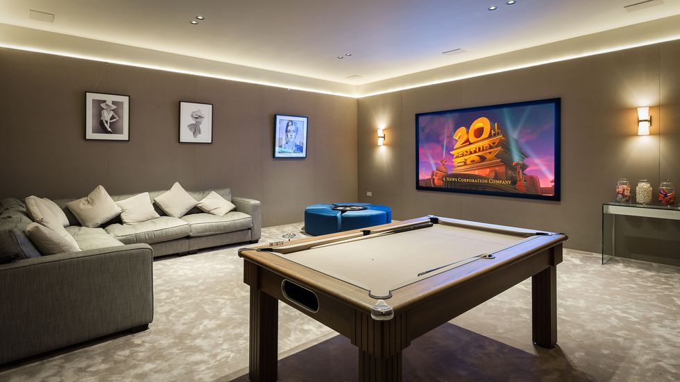 basement entertainment room with pool table and cinema screen