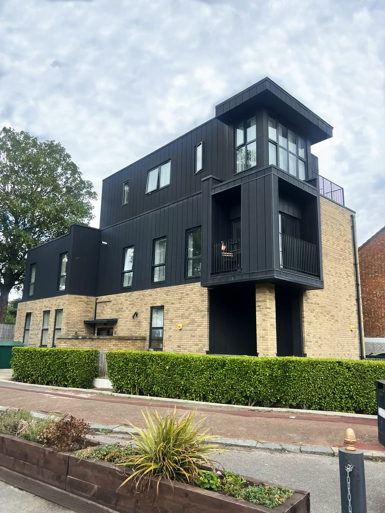 Exterior side of a new build property of bricks and metal cladding