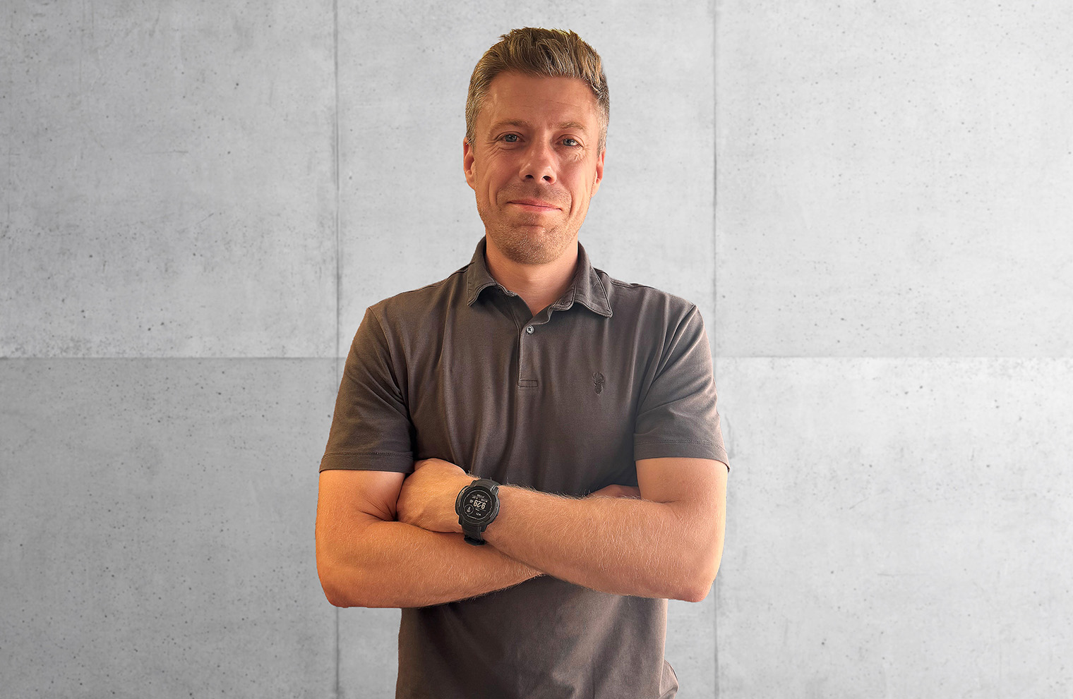 Senior Technician David Cobb in a dark grey top against a polished concrete wall